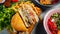 Close-up shot of a sliced hamburger and lots of healthy food bowls.