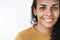 Close-up shot of smiling happy and delighted friendly-looking african-american woman with curly hair in mustard t-shirt