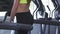 Close up shot of a sportswoman with perfect running on a treadmill