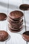 close-up shot of stack of delicious glazed chocolate cookies on white