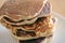 Close-up shot of stack of homemade pancakes, fresh and hot prepare before pouring syrup in white dish on wooden table, selective