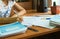 Close up shot of teacher desk. Academic teacher holding pen and