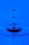 Close-up Shot of Three Blue Water Droplets On Tranquil Water Surface