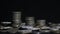 Close up shot of three stacks of silver old coins with a dark background