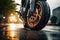 Close up shot of a tire of a motorcycle going on the road with a motion blur.