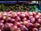 Close up shot of a tray of red onions at a grocery store