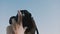 Close-up shot of two photographer hands holding a digital photo camera up outdoors on a sunny clear day slow motion.