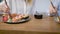 Close-up shot of a two plates of different sushi rolls, girl eating sushi with chopsticks.