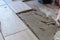 Close up shot of unfinished floor tiles installation in kitchen