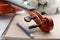 Close-up shot violin headstock orchestra instrumental over white wooden background select focus shallow depth of field