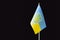 Close up shot of waving ukrainian flag over black background