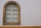 Close up shot of a window blocked with white wooden material on a white wall