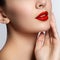 Close-up shot of woman lips with glossy red lipstick. Glamour red lips make-up, purity skin. Retro beauty style. Beautiful model