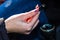 Close up shot of a woman`s hand holding an usb cable in her car