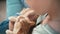 Close-up shot of woman`s hands petting a cute ginger cat.