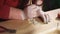 Close up shot of a woman`s hands, who cuts a petal for a stained glass window