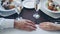 Close-up shot of young lovers holding hands on table at romantic dinner in classy restaurant. Sparking champagne glasses