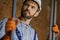 Close up shot of young male builder wearing hard hat looking focused, holding metal studs for drywall while working at