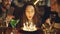 Close-up shot of young pretty woman blowing out candles on birthday cake. Happy people are laughing and clapping hands.