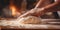 Close-up shots of a baker& x27;s hands expertly kneading dough, shaping bread .