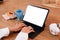 Close-up shots at the hands of female businesswomen are typing documents using a notebook computer on a wooden table with a coffee