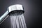 Close up of shower head against dark black background.