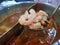 Close up of shrimp on blurred double flavor hot pot at restaurant,