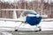 Close-up shrouded small sports airplane at winter