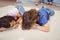 Close-up of siblings relaxing on carpet