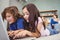 Close-up of siblings using laptop at home