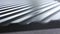 Close up side of black wavy roof tiles on blurred background. Action. Black wavy roofing material, constructional