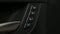 Close up for the side door buttons of a modern luxury car interior. Action. Car salon details, small black buttons of a