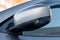 Close-up of the side left mirror with rear veiw 3d camera and window of the car body gray SUV on the parking after washing in auto