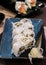 A close-up side shoot of Uramaki sushi rolls with fresh salmon, avocado and philadelphia cheese, covered with sesame seeds