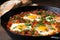 close-up side shot of shakshuka with runny yolks