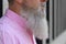 Close up side view of a bearded grey-haired man