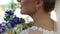 Close-up side view of a beautiful happy woman bride with a chic bouquet