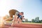 Close-up side view of cropped people ready to race on track field