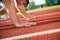 Close-up side view of cropped people ready to race on track field