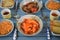 Close up side view of a dinner table with small dishes of Chinese food