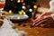 Close-up side view hands of unrecognizable young woman serving tableware waiting for friends to have dinner Christmas