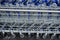 Close-up side view of a stacked blue metal supermarket trolleys