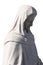 Close up side view of stone sculpture of virgin mary on white background