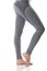 Close up side view of woman legs stretching the muscles of the foot in gray sports thermal underwear with pattern.