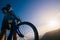 Close up silhouette of an athlete mountain biker riding his bike on rocky mountains