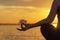 Close up silhouette hands. Woman do yoga outdoor. Woman exercising vital and meditation for fitness lifestyle club at the sunset