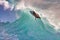 Close-up of a silhouetted surfer on a clean aquamarine wave on Maui.