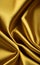 Close up silk fabric yellow, luxury themed abstract background. Silk fabric golden, satin fabric wave background.