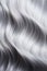 Close up silver grey wavy long shiny hair texture, trendy hair coloring, female hair fashion.