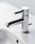 Close-up silver tap in white minimal bathroom washbasin with decorations. Generative AI